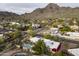 Aerial view of a neighborhood and home with a pool, with mountain views in the background at 7232 N 22 Nd St, Phoenix, AZ 85020