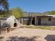 Backyard with a brick outdoor kitchen, spiral staircase, and lush green grass at 7232 N 22 Nd St, Phoenix, AZ 85020