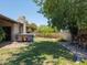 Fenced backyard with mature trees, green grass, a hot tub and stacked wood at 7232 N 22 Nd St, Phoenix, AZ 85020