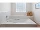 Bright bathroom features a built-in bathtub, tiled walls and a glass block window at 7232 N 22 Nd St, Phoenix, AZ 85020