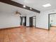 Open bedroom featuring exposed beams, tile floors, and multiple entryways at 7232 N 22 Nd St, Phoenix, AZ 85020