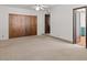 Bedroom with neutral carpet, a ceiling fan and a closet with wood sliding doors at 7232 N 22 Nd St, Phoenix, AZ 85020
