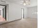Spacious bedroom featuring a ceiling fan, white walls, and access to the hallway and bathroom at 7232 N 22 Nd St, Phoenix, AZ 85020