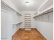 Walk-in closet featuring built-in shelving, hanging rods and terra-cotta tile flooring at 7232 N 22 Nd St, Phoenix, AZ 85020