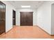 Hallway featuring brick accent wall, double doors and beautiful terracotta tile flooring at 7232 N 22 Nd St, Phoenix, AZ 85020