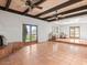 Bright living room features a beamed ceiling, tile floors and access to the outdoors at 7232 N 22 Nd St, Phoenix, AZ 85020