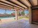Covered patio with ceiling fan, brick columns, and an outdoor kitchen and swimming pool in the background at 7232 N 22 Nd St, Phoenix, AZ 85020