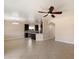 Open concept living area with tile floors, a ceiling fan, and a view of the kitchen at 737 E Harwell Rd, Phoenix, AZ 85042