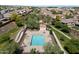 Aerial view of a community pool with lounge chairs and a small shelter surrounded by lush greenery at 737 E Harwell Rd, Phoenix, AZ 85042