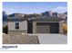 Contemporary single-story home featuring a two-car garage, stone accents, and desert landscaping at 7377 W Buckhorn Trl, Peoria, AZ 85383