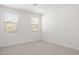 Neutral bedroom with carpet and two windows at 7428 W Buckhorn Trl, Peoria, AZ 85383