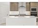 Kitchen island with sink and modern stainless steel appliances at 7428 W Buckhorn Trl, Peoria, AZ 85383