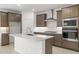 Modern kitchen with stainless steel appliances, subway tile backsplash and an island at 7428 W Buckhorn Trl, Peoria, AZ 85383