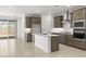 Modern kitchen with stainless steel appliances, subway tile backsplash and an island at 7428 W Buckhorn Trl, Peoria, AZ 85383