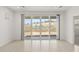 Bright living room features tile flooring and sliding glass doors to backyard at 7428 W Buckhorn Trl, Peoria, AZ 85383