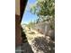 Spacious backyard featuring gravel ground cover, block fencing, and young trees at 7551 W Darrel Rd, Laveen, AZ 85339