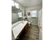 Bathroom with vanity, mirror, and wood-look flooring at 7551 W Darrel Rd, Laveen, AZ 85339
