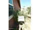 A Chiltepin plant grows near the house with a white sign for identification at 7551 W Darrel Rd, Laveen, AZ 85339