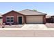 Charming single-story home with a two-car garage, xeriscaped front yard, and decorative star on the facade at 7551 W Darrel Rd, Laveen, AZ 85339