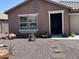 Charming single-story home with a decorated front door, desert landscaping, and elegant architectural details at 7551 W Darrel Rd, Laveen, AZ 85339