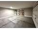 Spacious garage featuring concrete flooring, neutral walls, shelving, and an installed water heater at 7551 W Darrel Rd, Laveen, AZ 85339