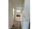 Hallway view leading to the bathroom with a wooden vanity and double sinks at 7551 W Darrel Rd, Laveen, AZ 85339
