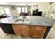 Open concept kitchen with stainless steel sink and gray countertops, flowing into a seating area at 7551 W Darrel Rd, Laveen, AZ 85339