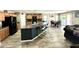 Spacious kitchen with a large center island, black appliances, and wood-look flooring at 7551 W Darrel Rd, Laveen, AZ 85339