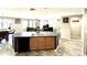 Kitchen island with sink, dishwasher, and bar seating in an open concept floorplan at 7551 W Darrel Rd, Laveen, AZ 85339