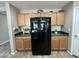 Kitchen area with wooden cabinets, black appliances, and countertops at 7551 W Darrel Rd, Laveen, AZ 85339