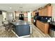 Well-equipped kitchen featuring a center island, modern appliances, and wood-look flooring at 7551 W Darrel Rd, Laveen, AZ 85339