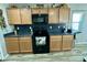 Kitchen featuring stainless steel appliances, wooden cabinets, and dark countertops at 7551 W Darrel Rd, Laveen, AZ 85339
