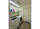 Functional laundry room featuring modern washer and dryer units, and storage shelves at 7551 W Darrel Rd, Laveen, AZ 85339