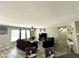 Bright living room with large windows, comfortable sofas, and wood-look flooring at 7551 W Darrel Rd, Laveen, AZ 85339