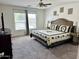 Comfortable main bedroom with neutral walls, large window, ceiling fan, and warm decor at 7551 W Darrel Rd, Laveen, AZ 85339