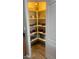 Corner kitchen pantry with organized shelving and hardwood flooring at 7551 W Darrel Rd, Laveen, AZ 85339