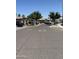 Image capturing a peaceful street scene with charming houses and mature trees at 7551 W Darrel Rd, Laveen, AZ 85339