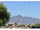 Street view of homes with mature landscaping, offering stunning mountain views at 7551 W Darrel Rd, Laveen, AZ 85339