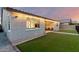 The outdoor space features a covered patio and manicured artificial turf, perfect for relaxation and recreation at 7829 W Warner St, Phoenix, AZ 85043