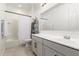 Neutral bathroom with a single sink vanity, framed mirror, and shower with white shower curtain at 7829 W Warner St, Phoenix, AZ 85043
