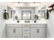 Bright bathroom features dual sinks, white cabinets and a large mirror at 7829 W Warner St, Phoenix, AZ 85043