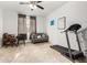 Carpeted room with a ceiling fan, desk, loveseat, chair, and treadmill at 7829 W Warner St, Phoenix, AZ 85043