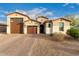 Charming single-Gathering home showcasing a tile roof, neutral stucco, and a spacious three-car garage at 7829 W Warner St, Phoenix, AZ 85043