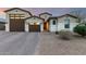 Charming single-Gathering home with a three-car garage and desert landscaping at 7829 W Warner St, Phoenix, AZ 85043