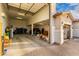 The oversized three car garage is well lit with painted walls at 7829 W Warner St, Phoenix, AZ 85043