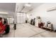 Garage featuring two doors, a red Jeep, home appliances, and various household items at 7829 W Warner St, Phoenix, AZ 85043