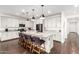 Bright kitchen with white cabinets, granite countertops, modern pendant lights, and stainless steel appliances at 7829 W Warner St, Phoenix, AZ 85043