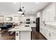 Modern kitchen showcasing a large island, granite countertops, sleek black appliances, and white cabinetry, perfect for Gathering gatherings at 7829 W Warner St, Phoenix, AZ 85043