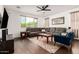 Inviting living room featuring hardwood floors, a comfortable leather sectional, and abundant natural light at 7829 W Warner St, Phoenix, AZ 85043