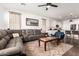 Cozy living room showcasing an open layout and hardwood floors, with seamless flow into the adjacent kitchen at 7829 W Warner St, Phoenix, AZ 85043